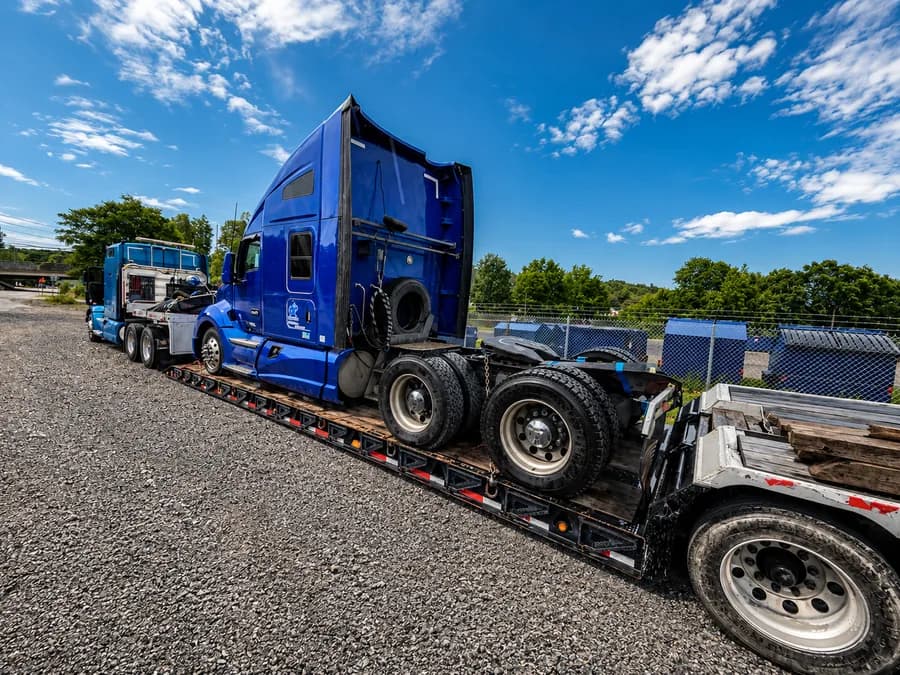 Commercial semi truck loaded on a lowboy trailer